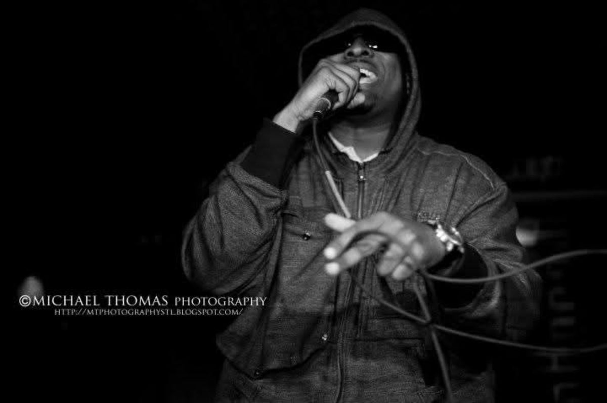MC J-Biggs performing live; photograph credited to Michael Thomas Photography.