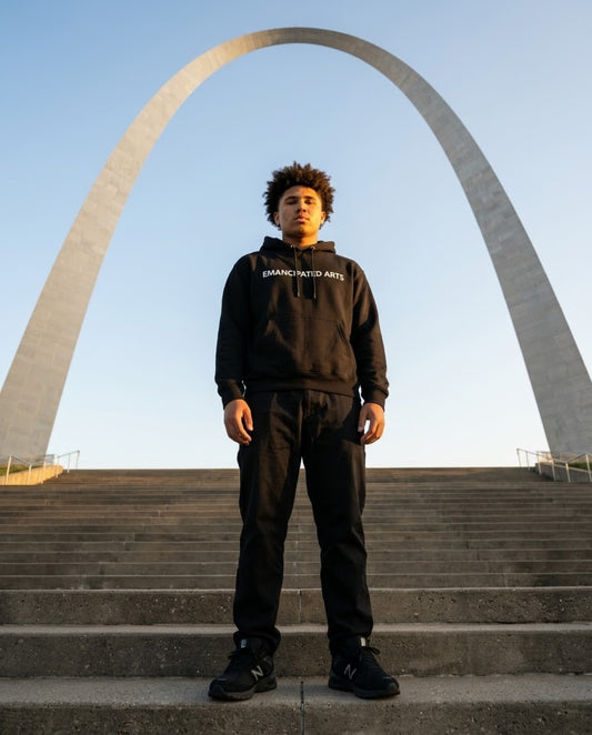 Emancipated Arts black hoodie modeled in front of the Gateway Arch